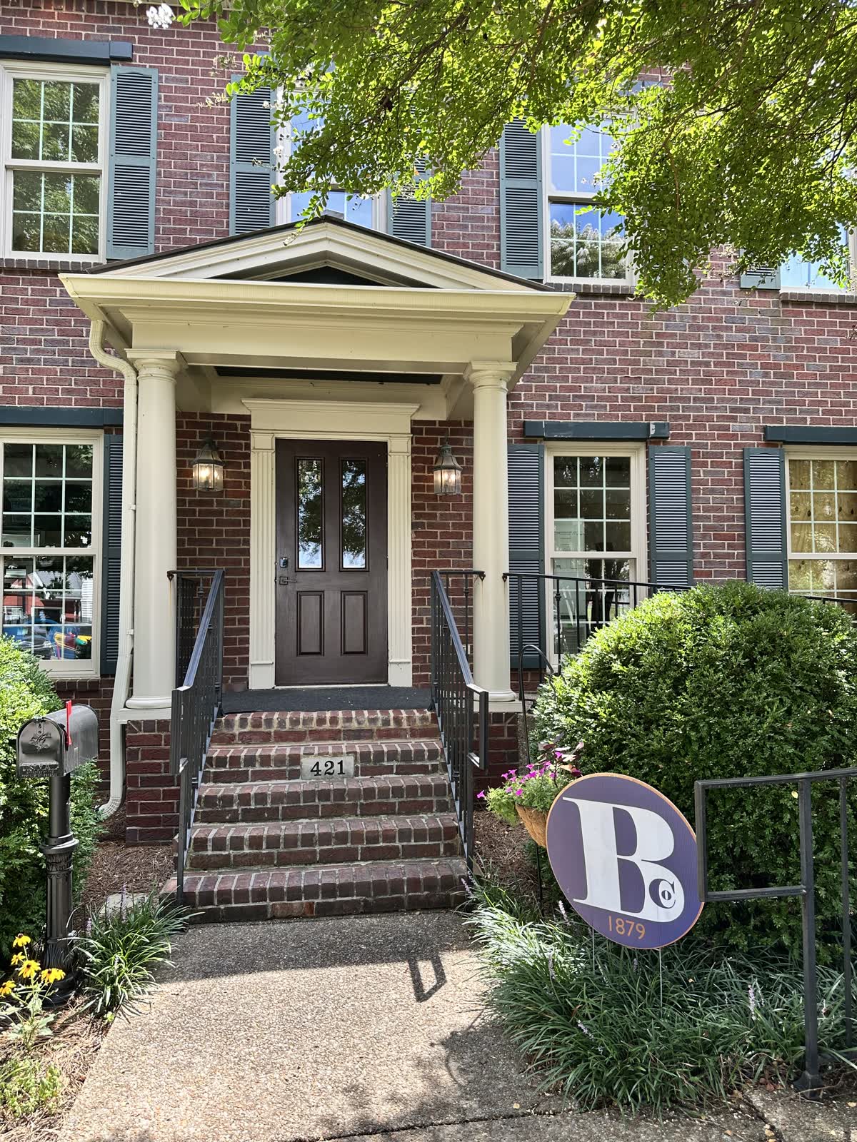 The Bock and Sons Company office on West College Street in Murfreesboro, with the company sign at the front walk.